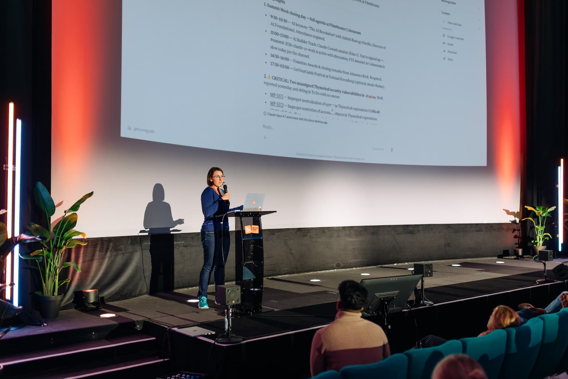 Speaker presenting AI strategy to a leadership audience in a theatre