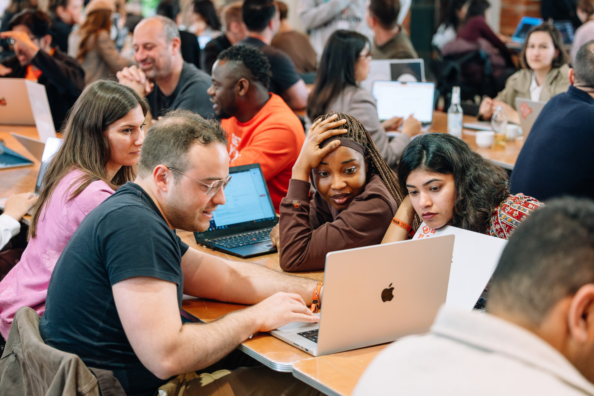 Participants working together on laptops during a hands-on AI session
